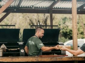 Chef workign at outdoor smoker BBQ in Country setting