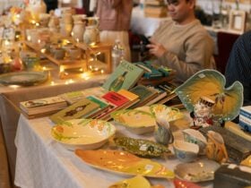 A market table covered in vintage books and ceramics.