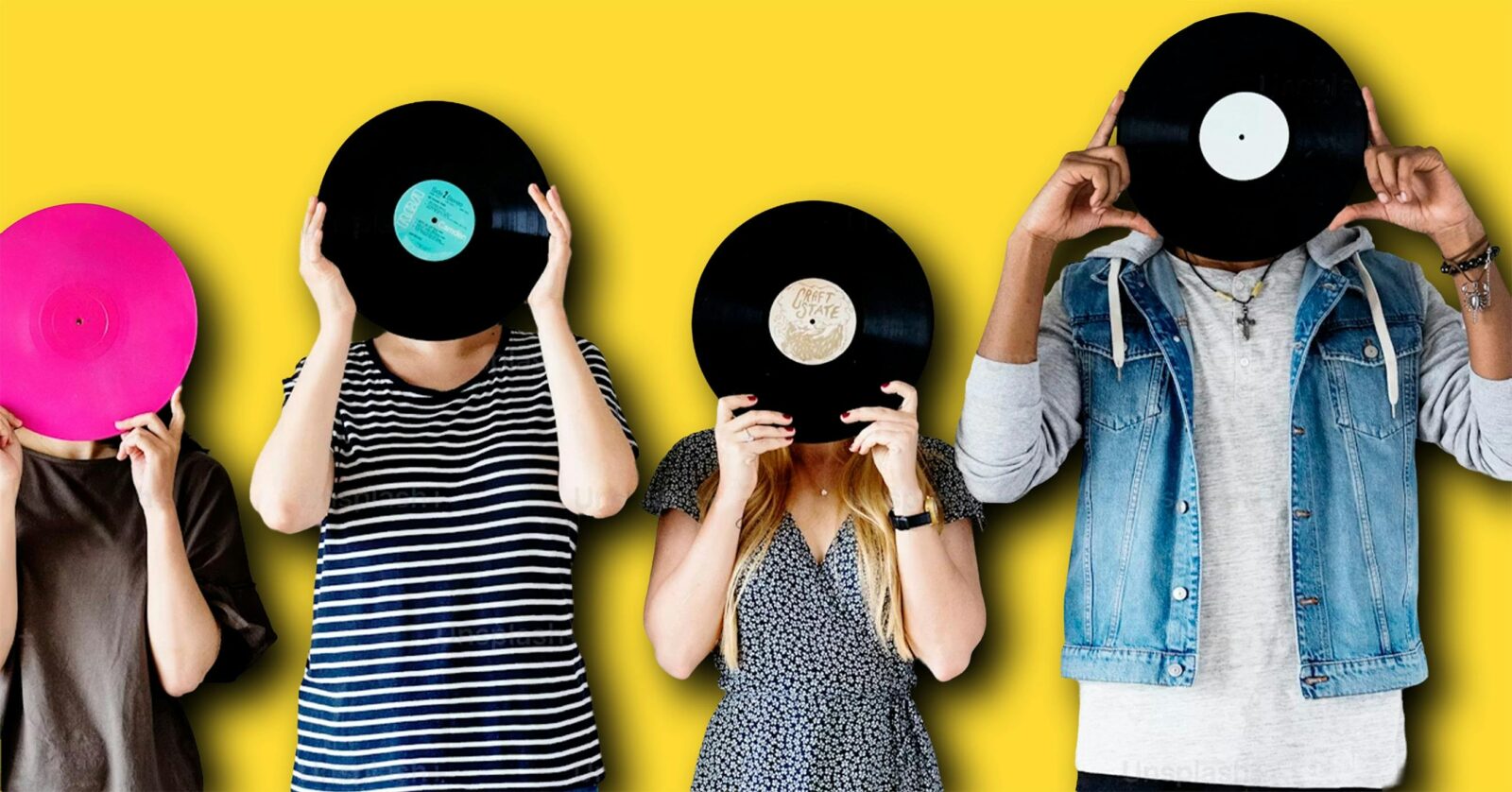 A group of people in a line, holding a vinyl record in front of their faces