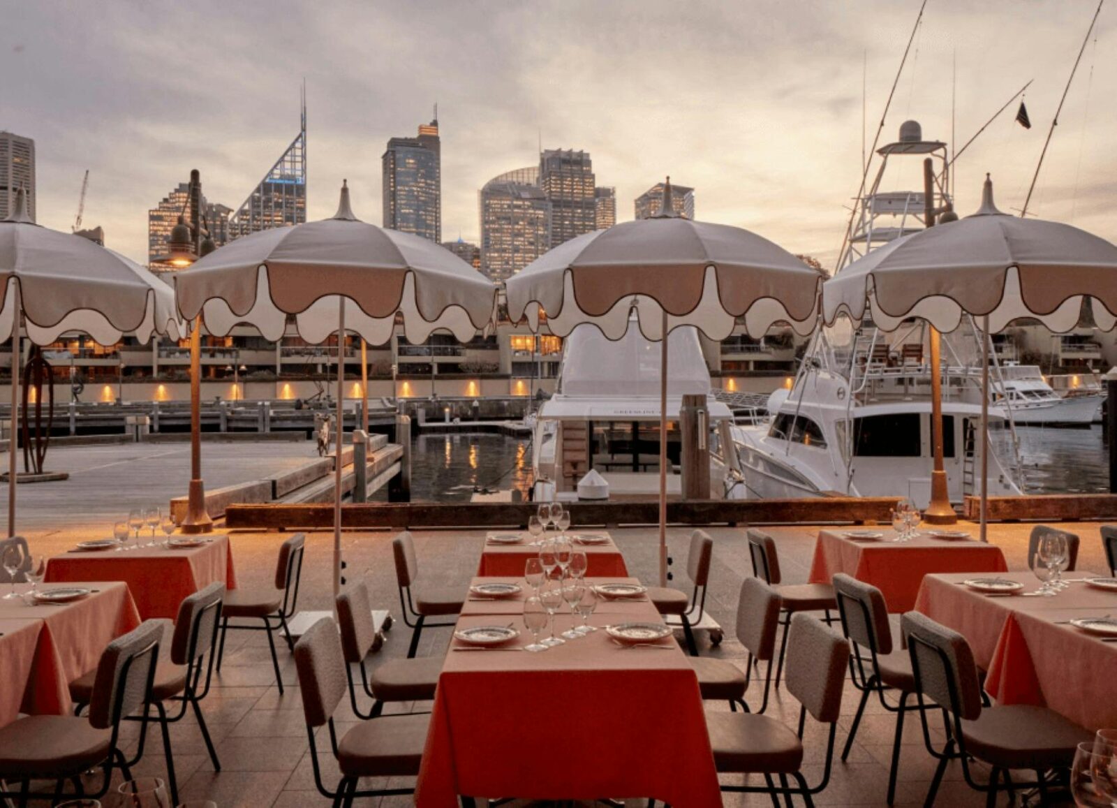 umbrellas and outdoor tables at sunset at Akti Greek Restaurant Woolloomooloo Sydney
