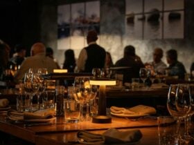 Ambient lighting tabl with lamp and wineglasses people in background