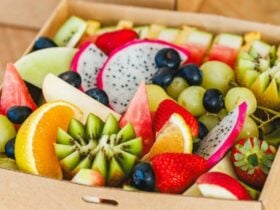 A serving box filled with a variety of cut tropical fruits