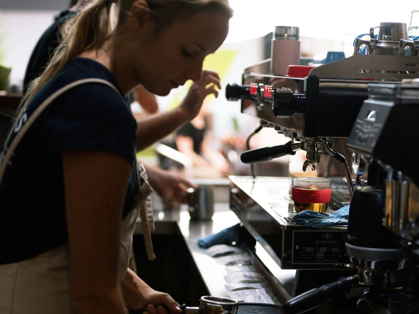 Barista making coffee at Brennans cafe