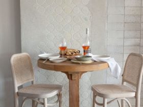 High table with two bar stools laden with snacks and rose at the Cheeky Dog