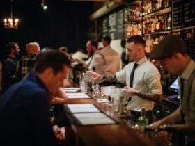 Bartender pouring cocktails for patrons at retro-chic bar Coal & Cedar in Newcastle
