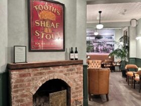 photo of internal space, seating, fireplace, old advertising sign