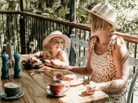 Mum and daughter having breakfast at cafe