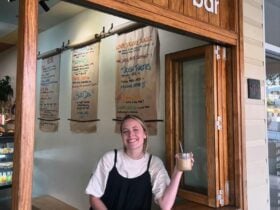 Girl holding up iced coffee