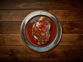 slow cooked lamb shoulder with pomegranate molasses and native herbs