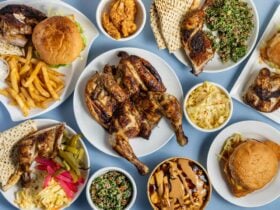 POV shot of chicken and various menu items on a blue table cloth