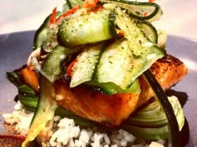 Miso glazed salmon, sushi rice, but choy, pickled cucumbers