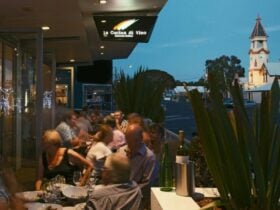 blurred image of diners eating outside at night