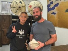 A happy customer with the chef and his ramen