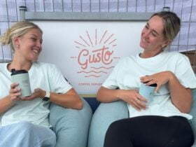 Two friends enjoying locally roasted coffee at Sandy Souls Surf and Coffee in Dalmeny, NSW – a vibra
