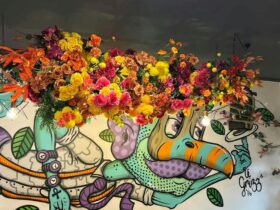 Mural of a man with flowers around it.