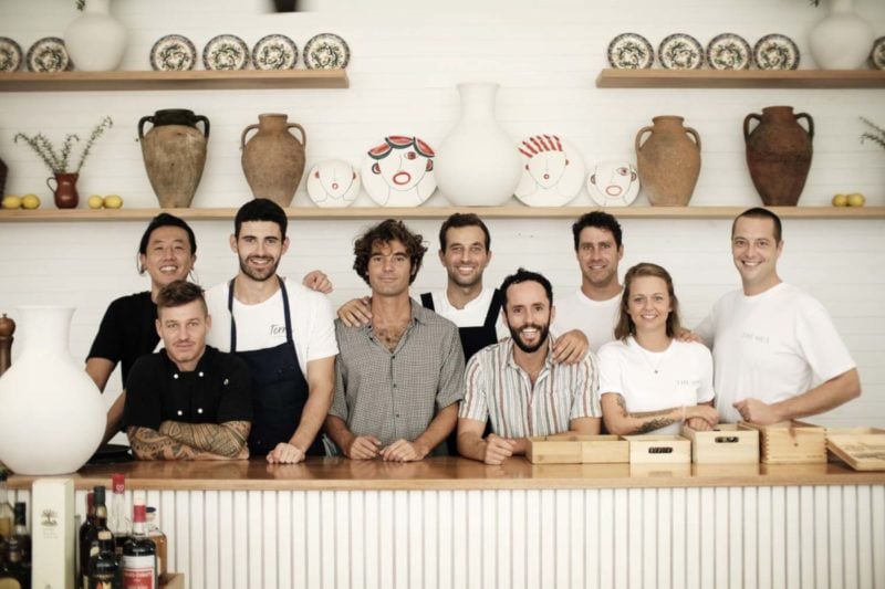 Staff at The Hut behind a white counter