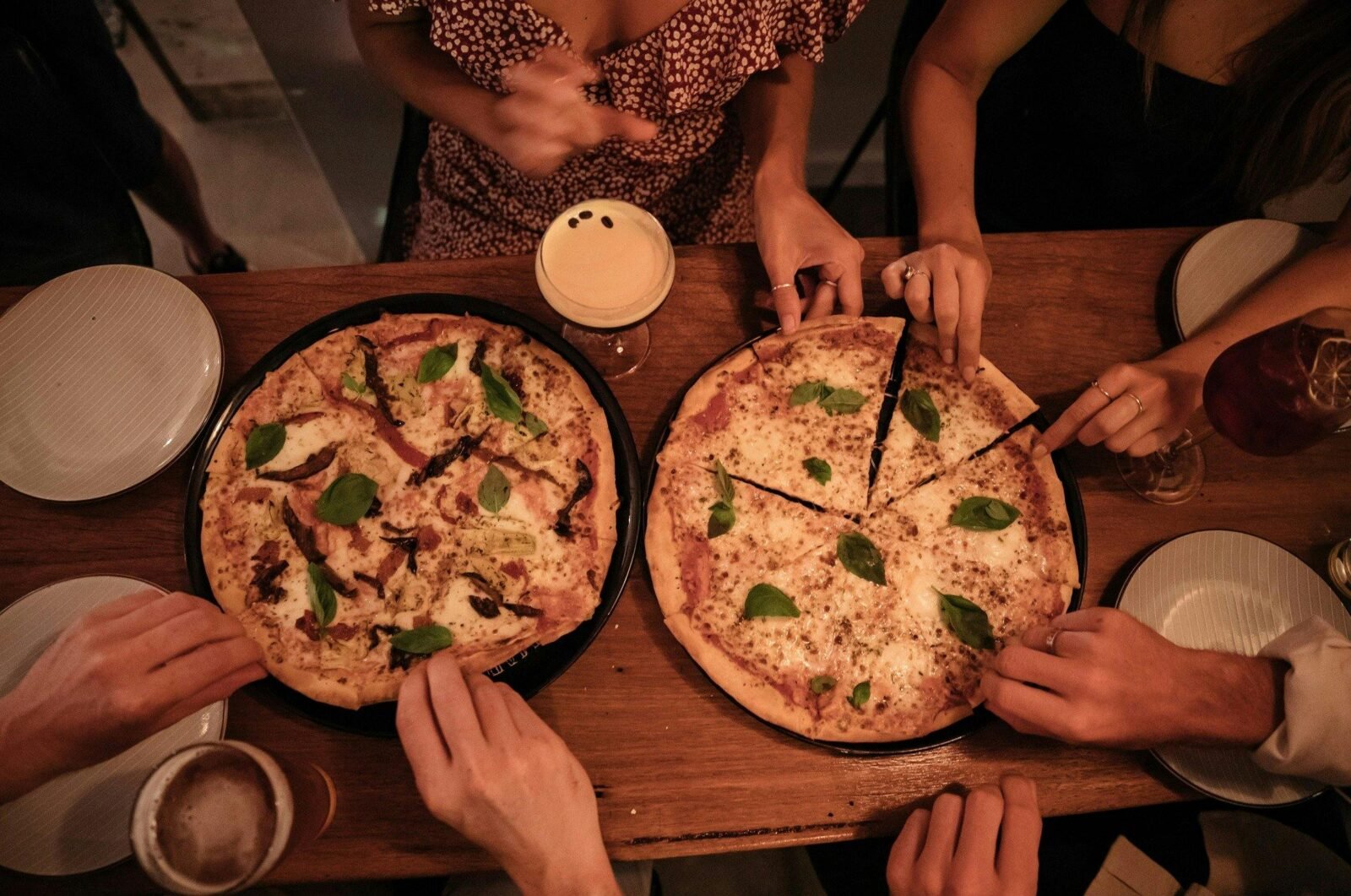 Friends enjoying beverages at the cinema-themed Savoy Bar in Long Jetty