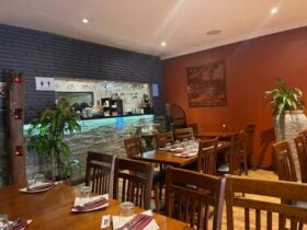 Wooden dining setting with Service bar in the backgound