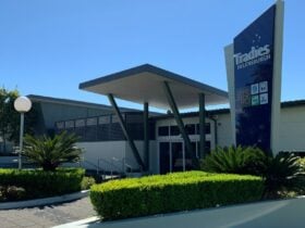 Front exterior of the Tradies Helensburgh club including gardens and signage