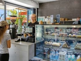 Serving a customer with a smile at Vault Cafe in Kempsey.
