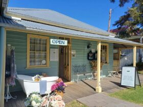 An old timber building with a bath in the front