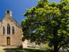 The exterior of Former St Bernards Church next to trees in Hartley Historic Site. Photo: John