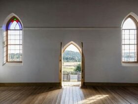 Interior arch stained glass windows and arch doorway at Sacred Heart Church in Hill End Historic