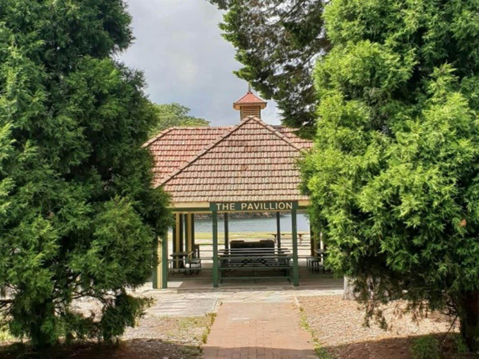 The Pavillion picnic shelter through trees in Ku-ring-gai Chase National Park. Photo: Nicole Ribera