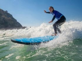 Girl in a wetsuit surfing a wave