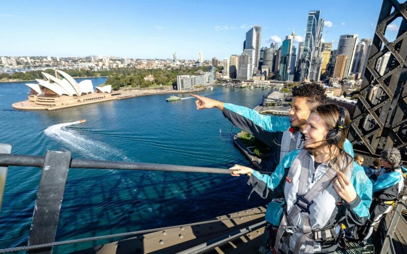 A couple on the Sydney Harbour Bridge looking out to the view of the Harbour