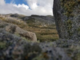 A Snowy Mountains hut, Whites River Hut, viewed from afar sitting in its landscape.