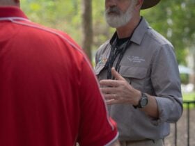 KCA tour guide talking to a visitor
