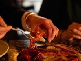 Guest eats food from fork