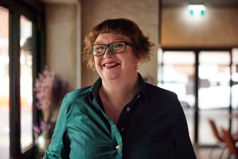 Smiling woman red hair green dress