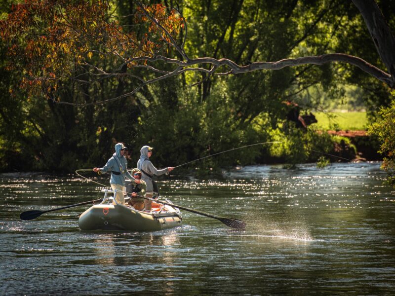 Drifting down the Tumut River fly fishing for trout.