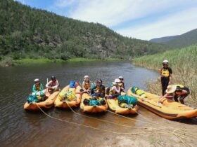 people sitting in rafts on the Snowy River.