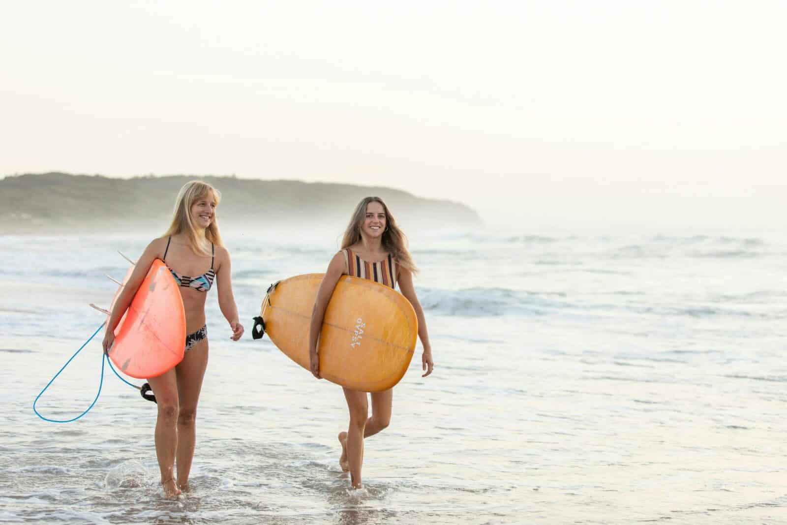 Women surfing Caves Beach