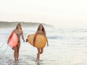 Women surfing Caves Beach
