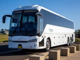 Destination Coaches luxury coach parked near a scenic Sydney foreshore ready for group travel