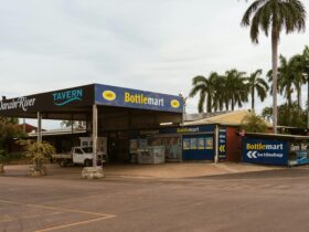 Front entrance of Darwin River Tavern with bottle shop and tropical surroundings