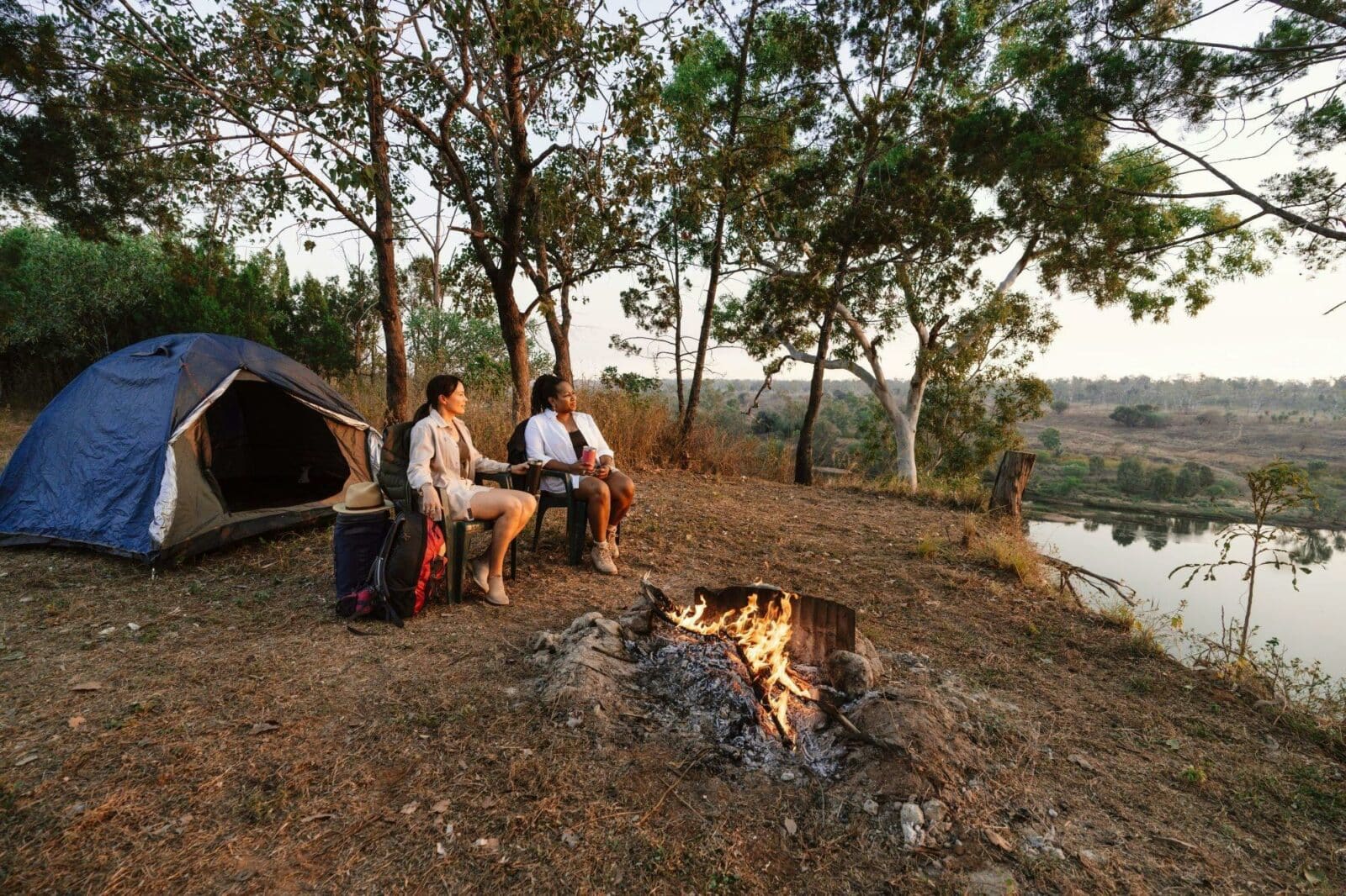 Two people camping beside Robinson River.