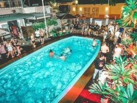 Guests swimming in the pool at Youth Shack Backpackers.