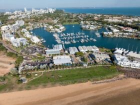 Cullen Bay Marina and Precinct birdseye view of the beach and lawns with the Marina and Darwin city.