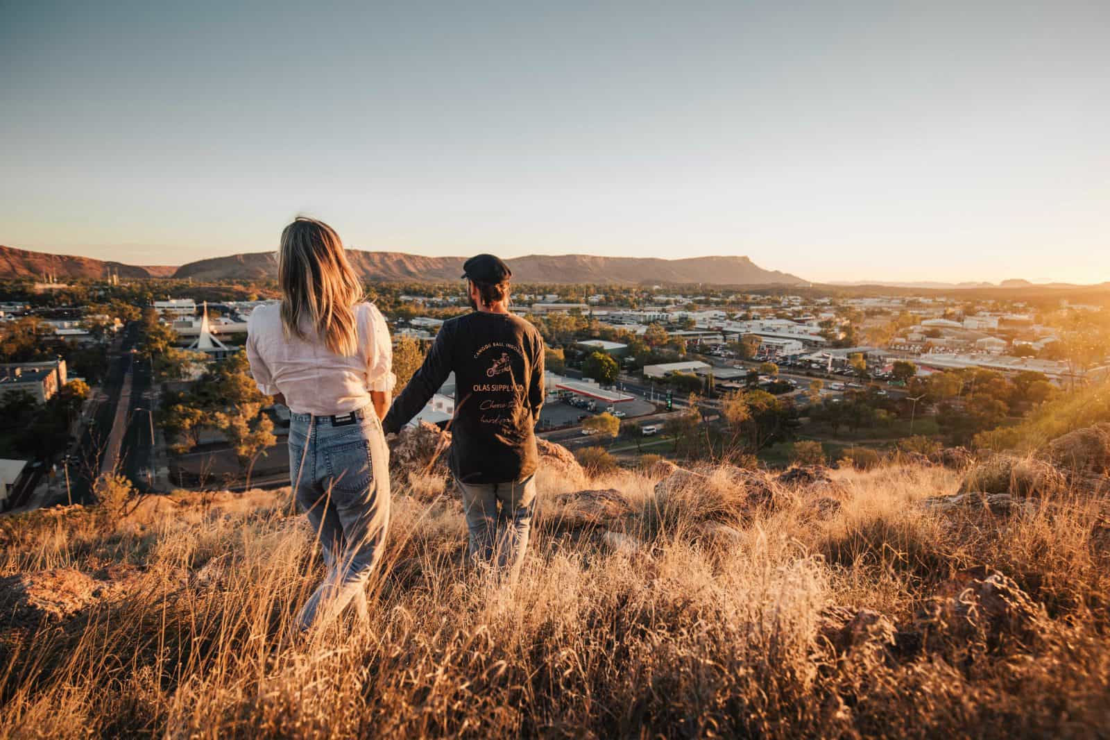 A young couple walking down ANZAC Hill