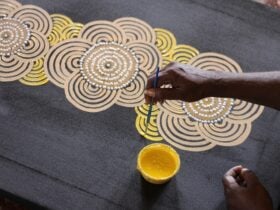 Cecelia paints the three prominent land formations of the central desert region.