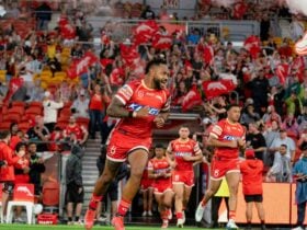 Dolphins players running out of the players race with crowd in grandstand cheering