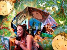 A multi-coloured image focusing on a woman holding a a microphone. In the background, a giant book