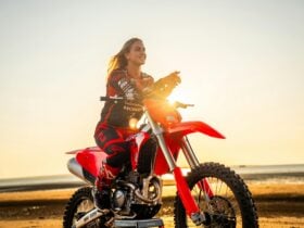 Charli Cannon sitting on a motorbike at Mindil Beach