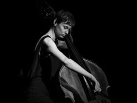 Photograph of musician Rhiannon Oakhill-Steel playing a double bass