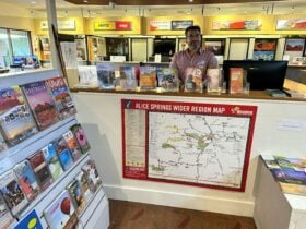 Friendly staff member at the Yulara Visitor Information Centre service desk